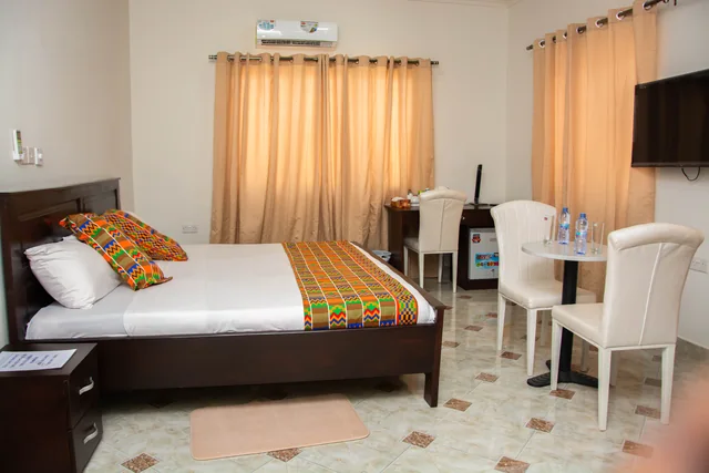 Guest bedroom with seating and minibar